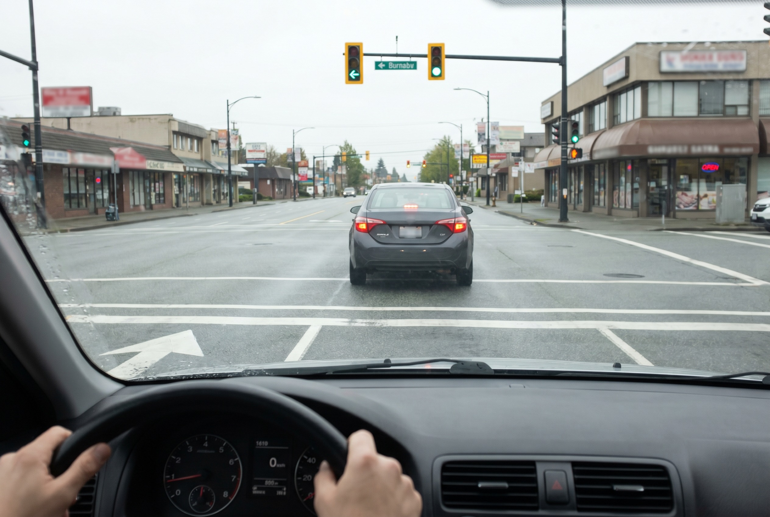 You are turning left at a green light. The oncoming vehicle has no signal but slows slightly. What should you do?