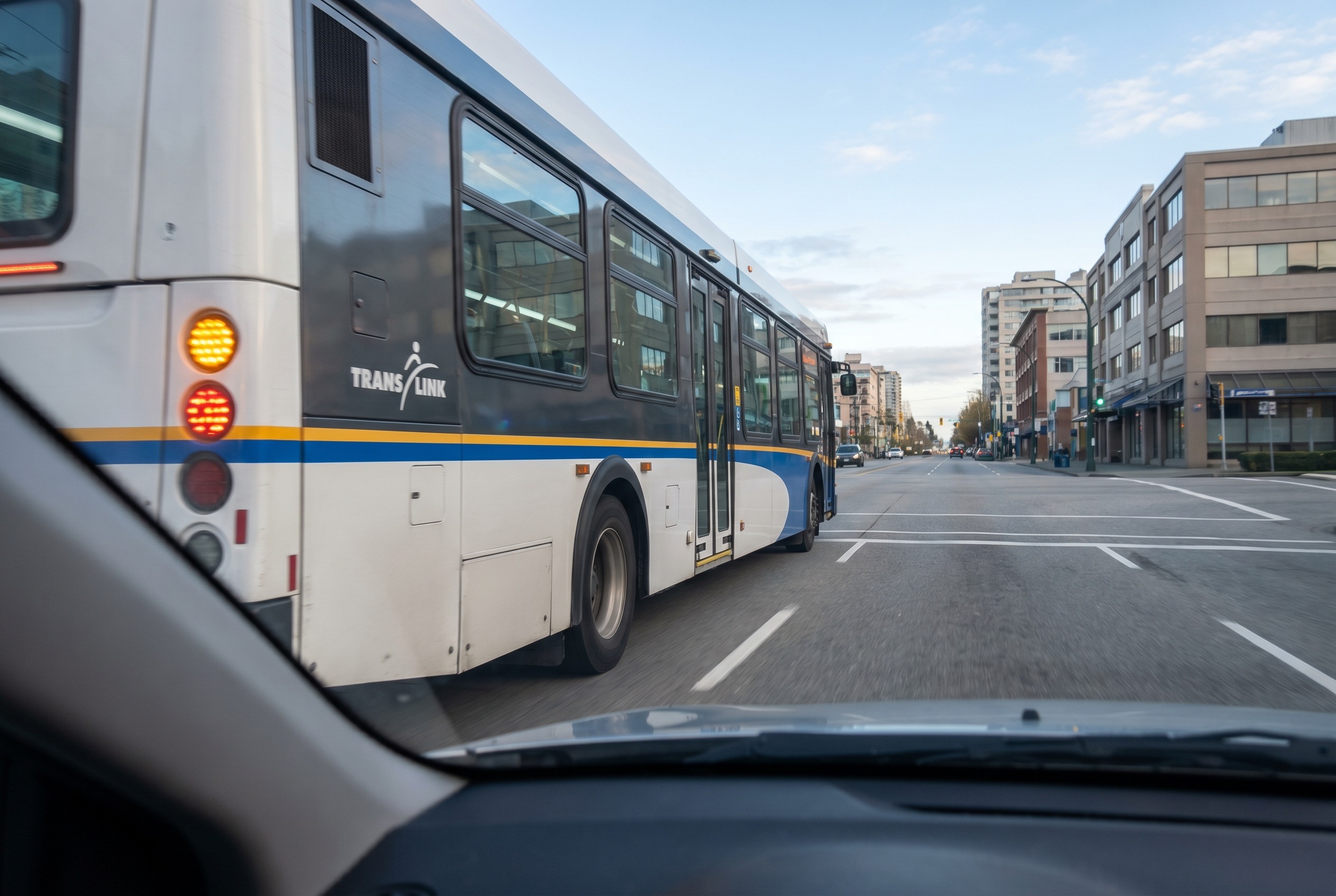 You are driving beside a bus that signals to re-enter traffic. What should you do?