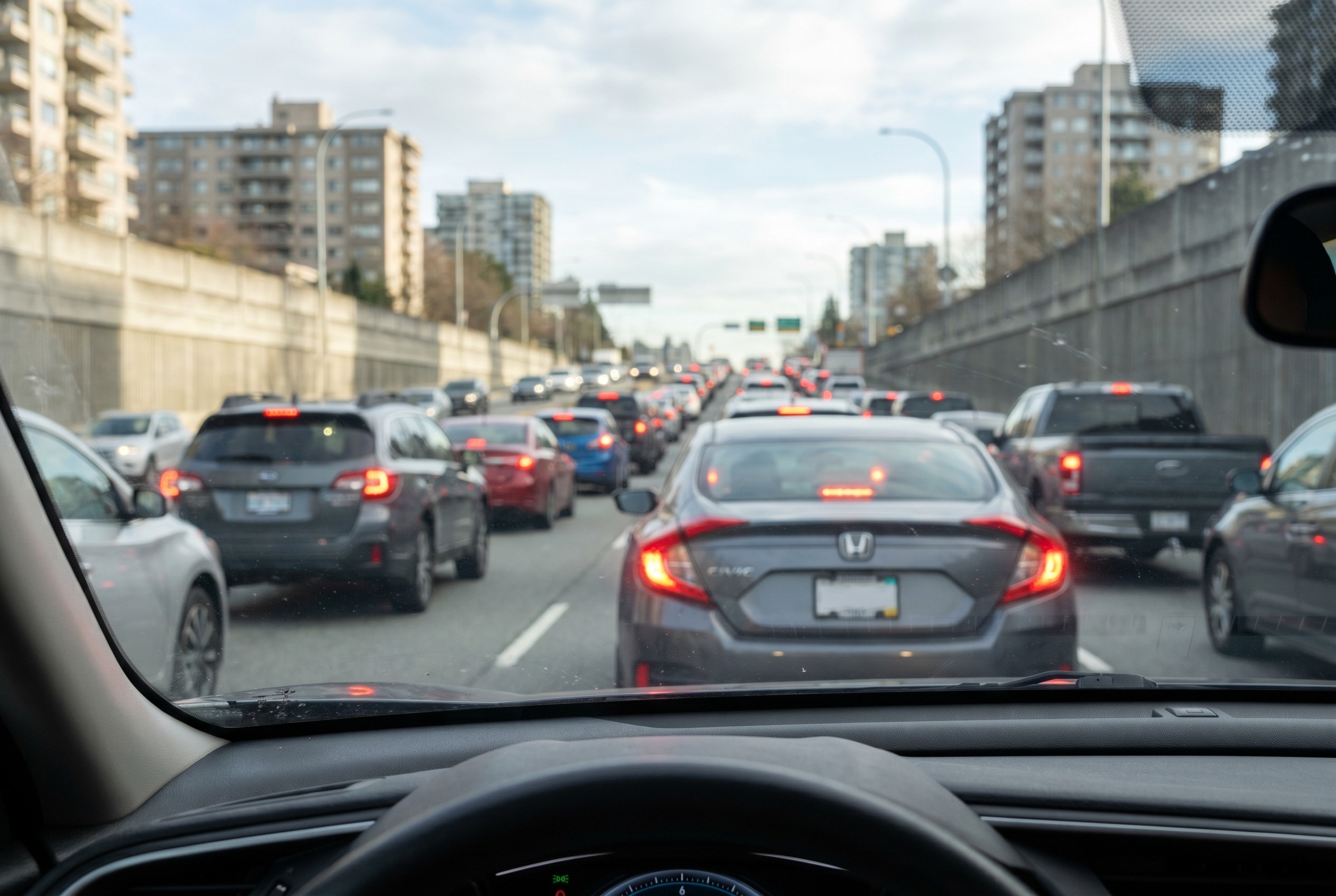 You are in heavy traffic and see brake lights spreading backward quickly. What does this indicate?