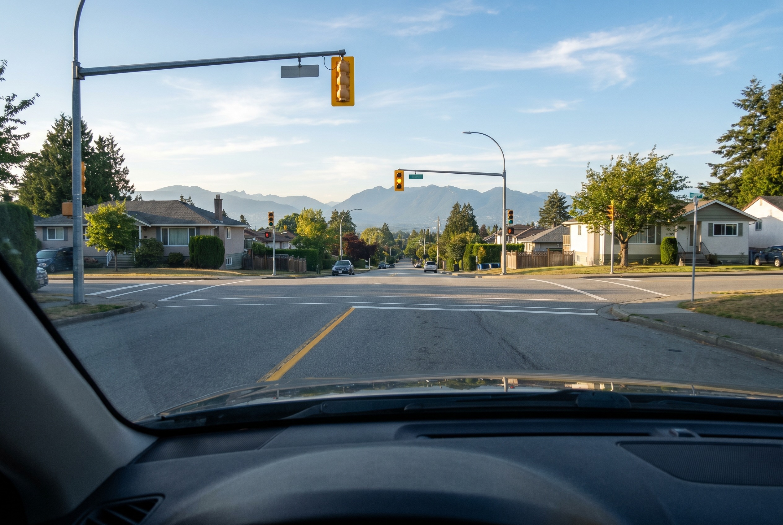 You approach a yellow light while going downhill in dry conditions. What should you consider?