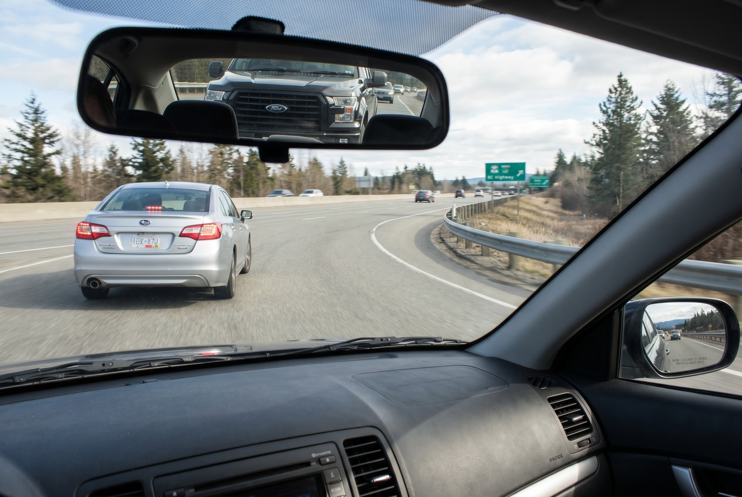 You are merging and a driver slows slightly to allow you in, but traffic behind them is close. What should you do?