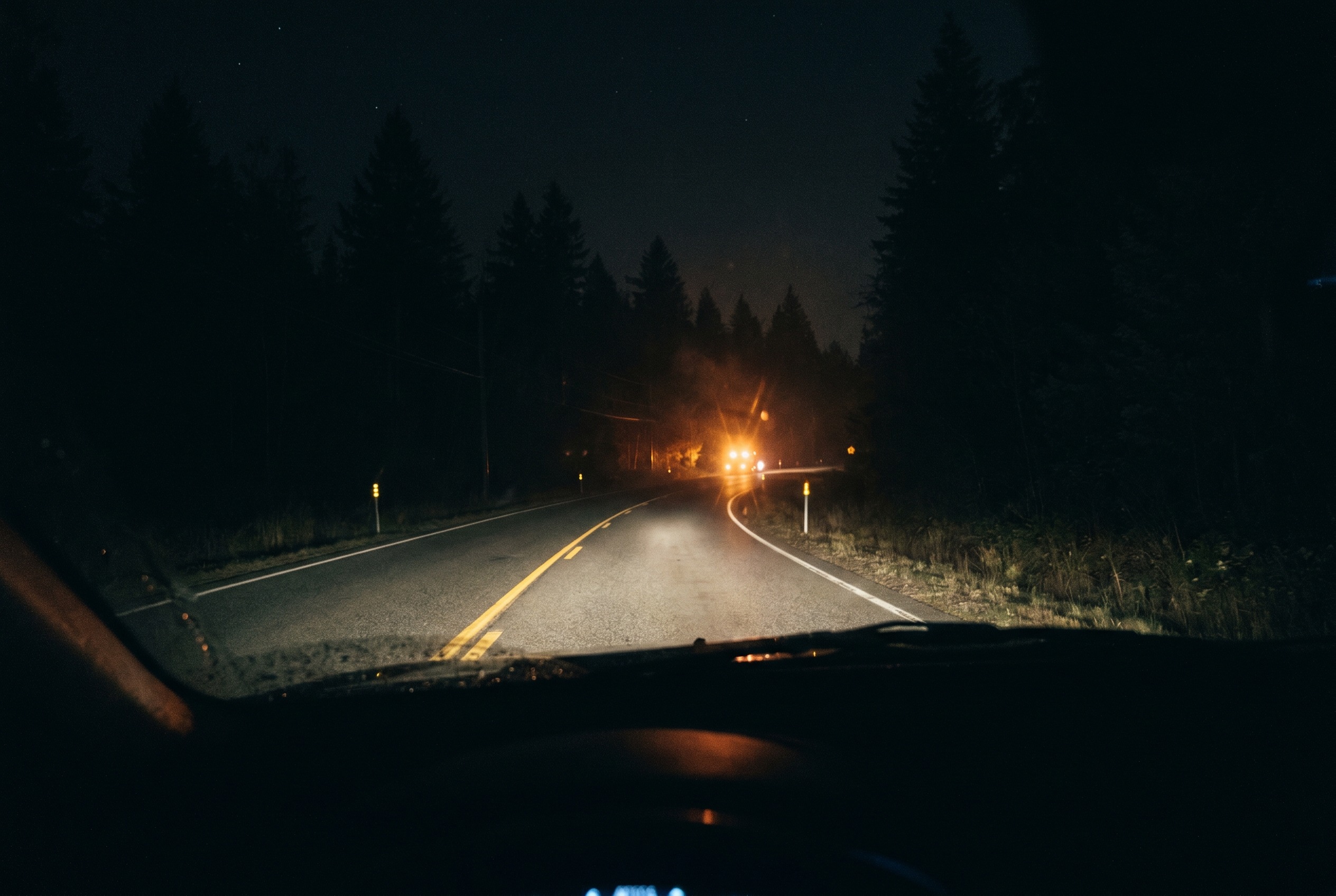 You are driving at night and see flickering lights ahead. What could this indicate?
